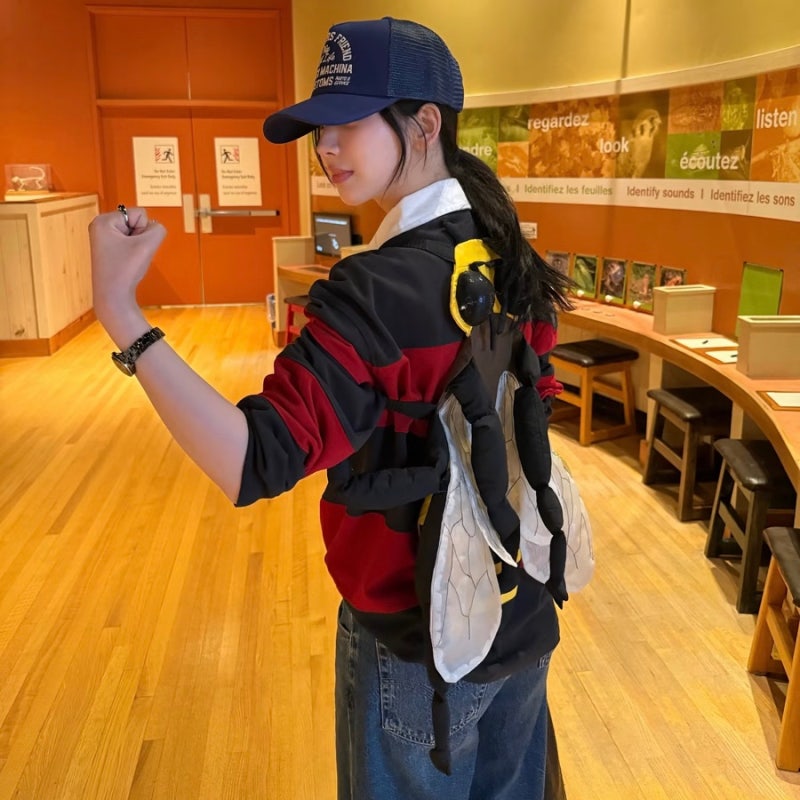 Karina looks cute in a rugby shirt and baseball cap... 'girlfriend look' fashion