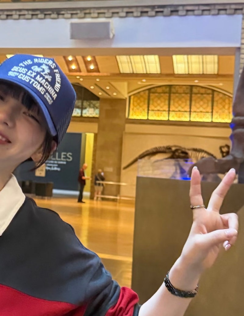 Karina looks cute in a rugby shirt and baseball cap... 'girlfriend look' fashion